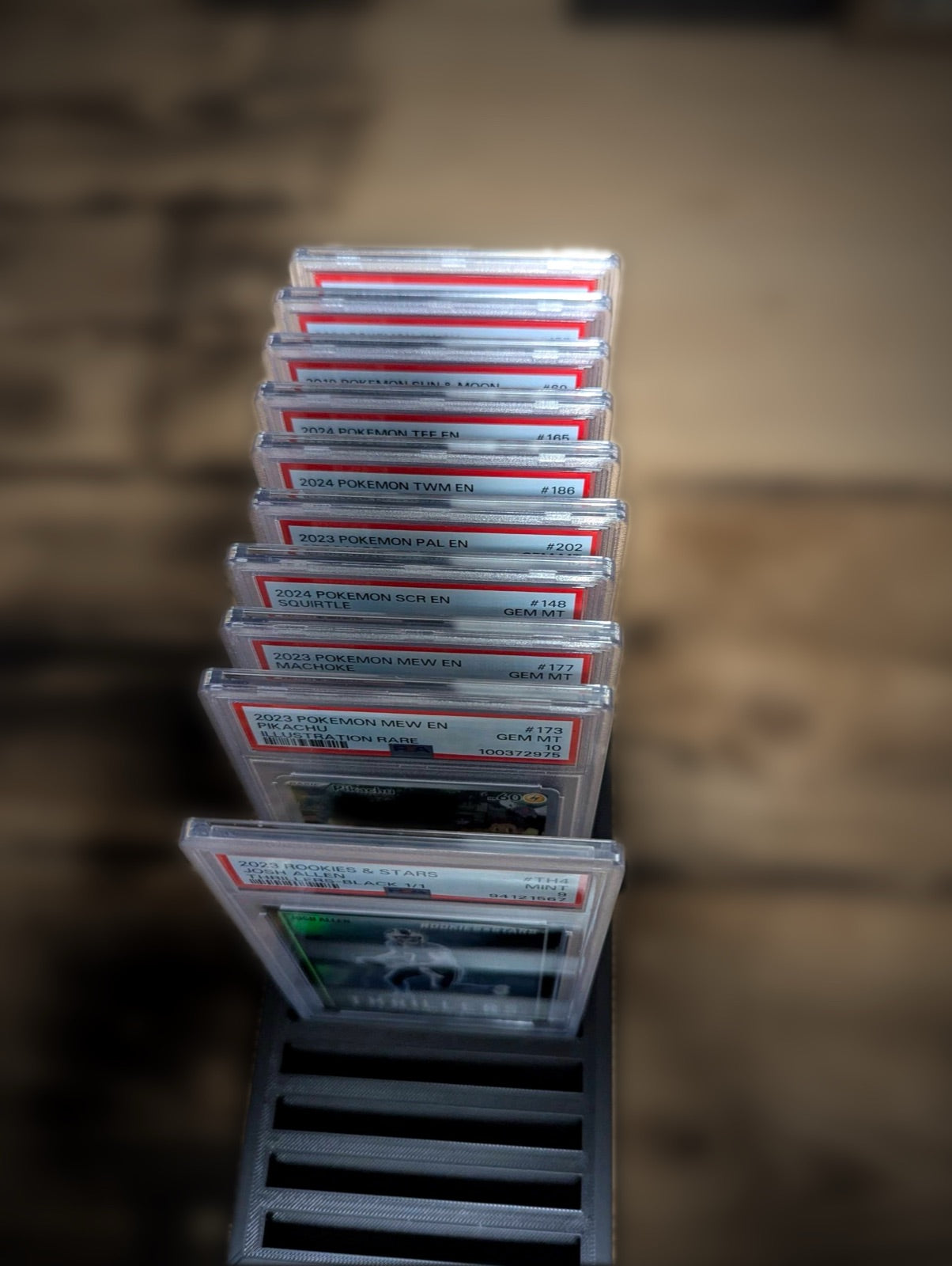 Ten graded slabs lined up in a tray, seen from above